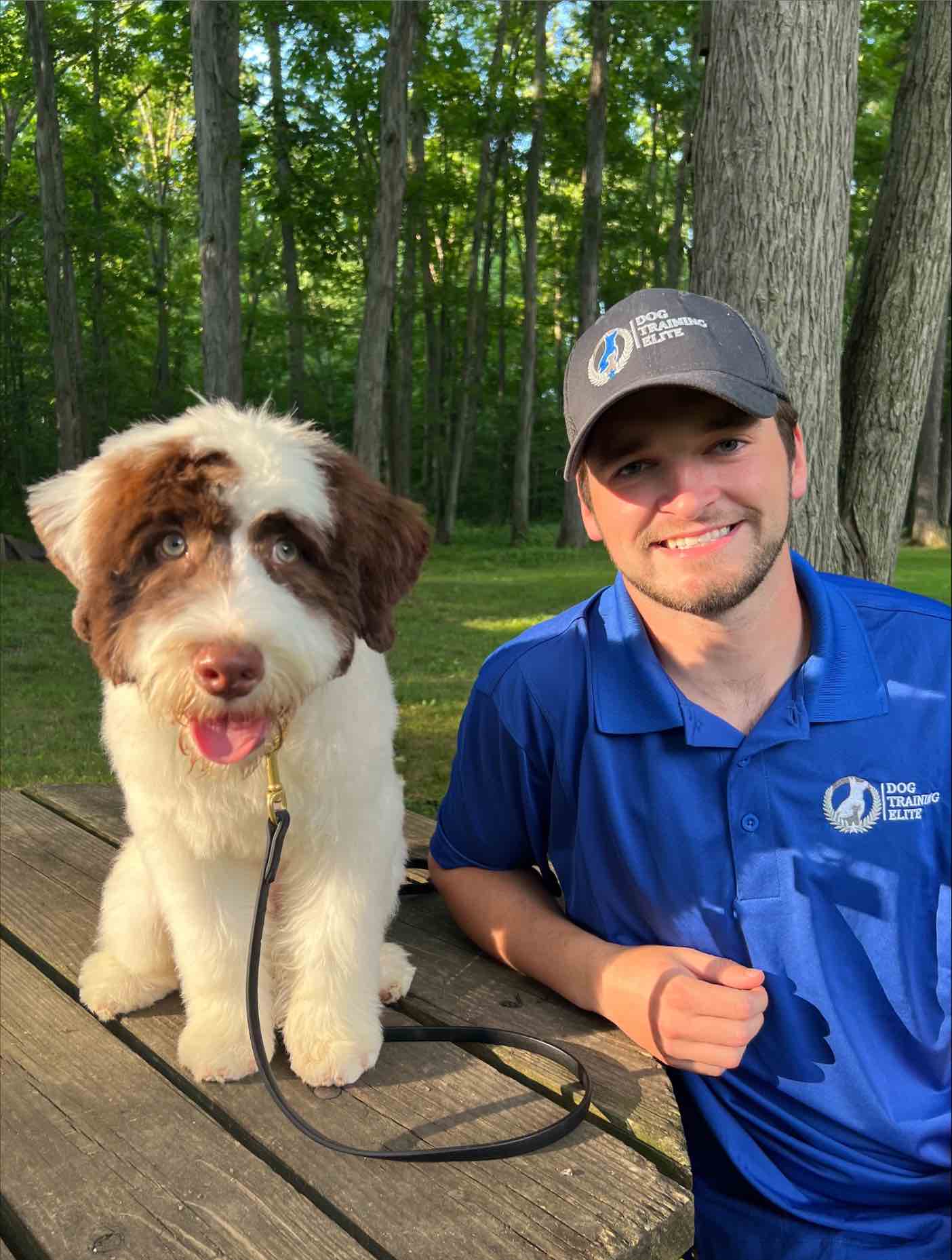 With training and support, you'll smile about Dog Training Elites work from home franchise just like this trainer and his pup!
