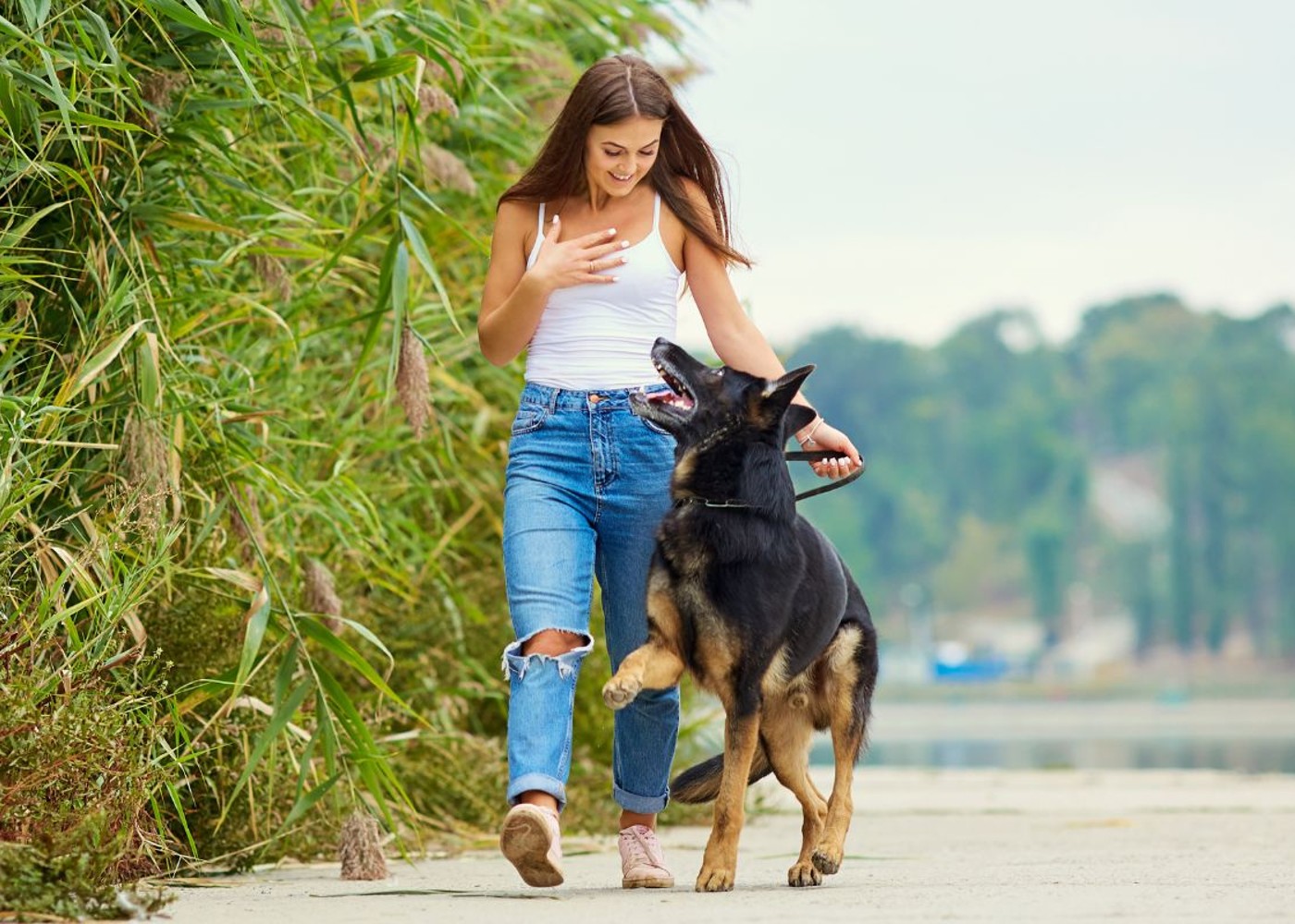 A woman walking with her dog - learn essential tips for managing difficult dogs with {fran_db}.
