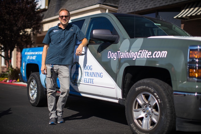 Dog Training Elite's Franchisee standing in front of company truck.