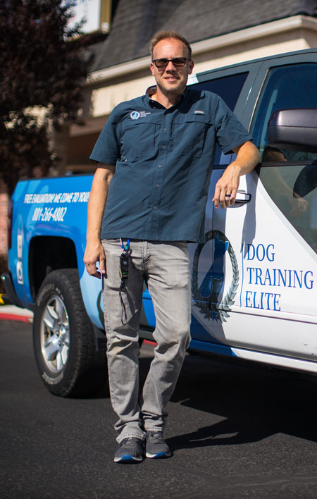 This man leaning against his Dog Training Elite car knows that joining Dog Training Elite is one of the best franchise investments.
