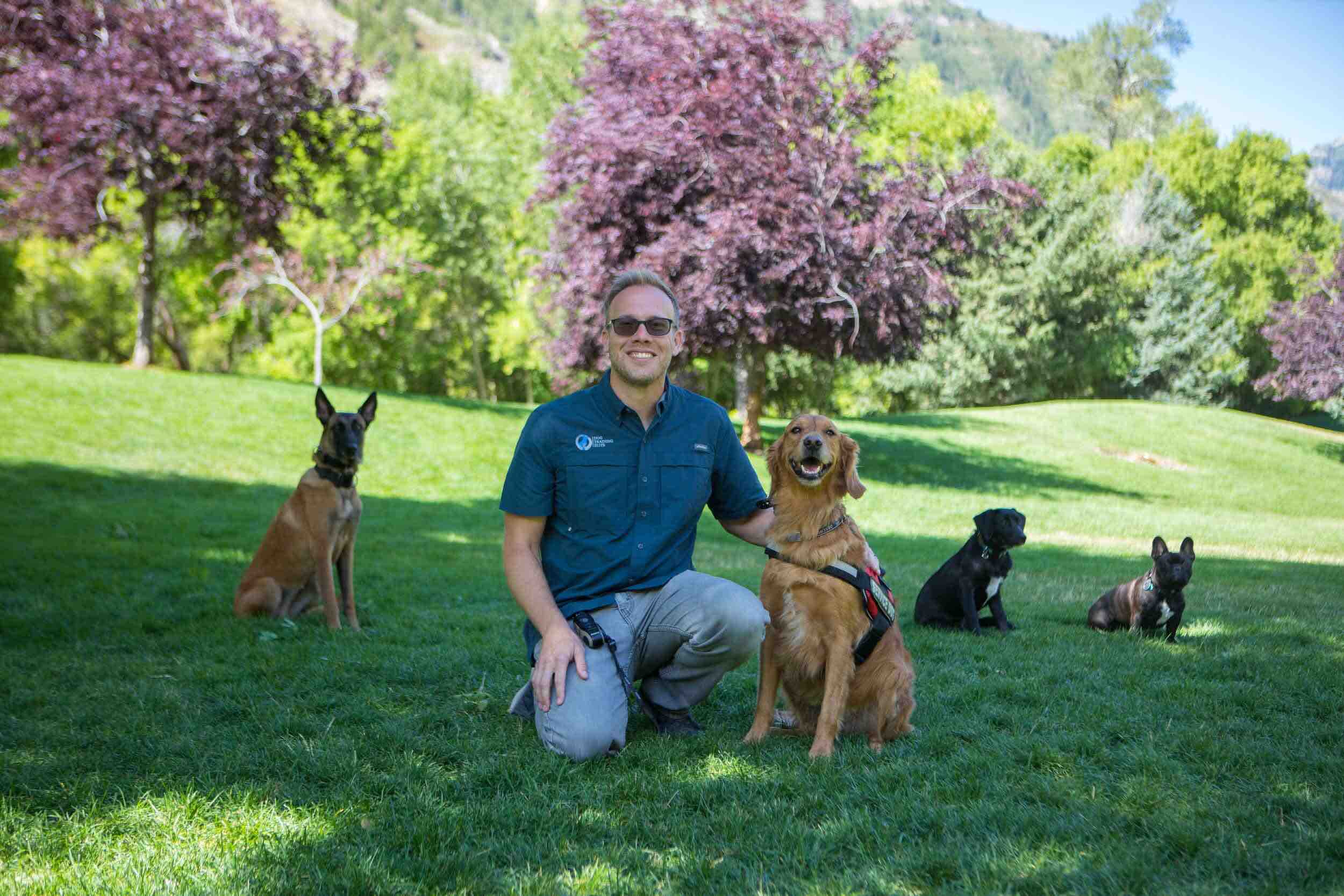 owner of one of the best pet franchises kneeling next to his dog