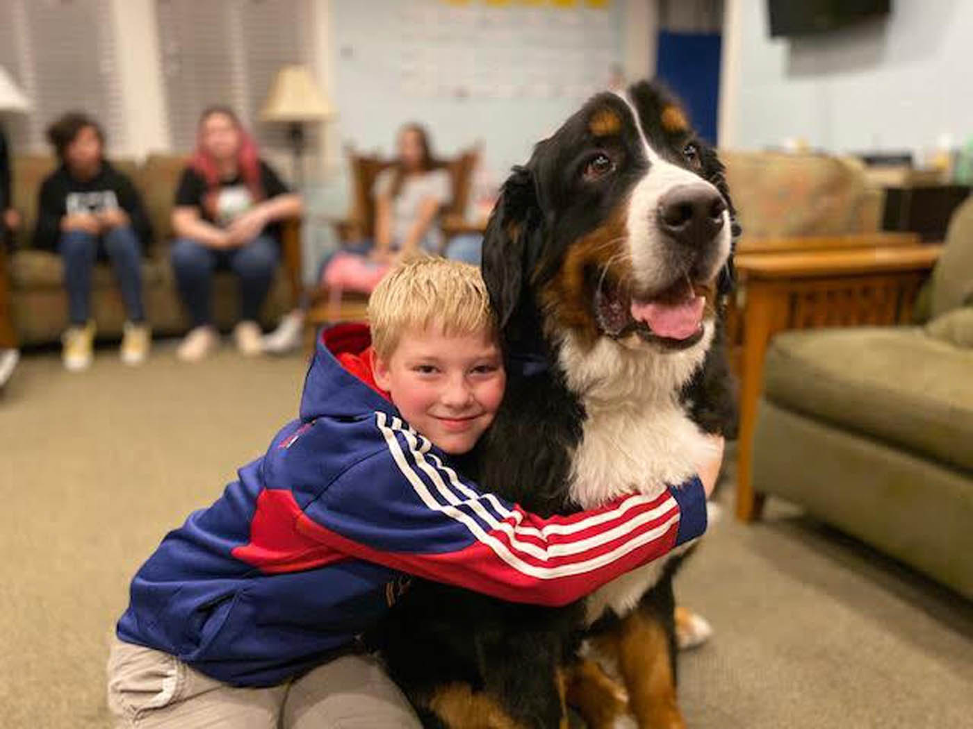 A child with their happy, obedient dog with training from Dog Training Elite.