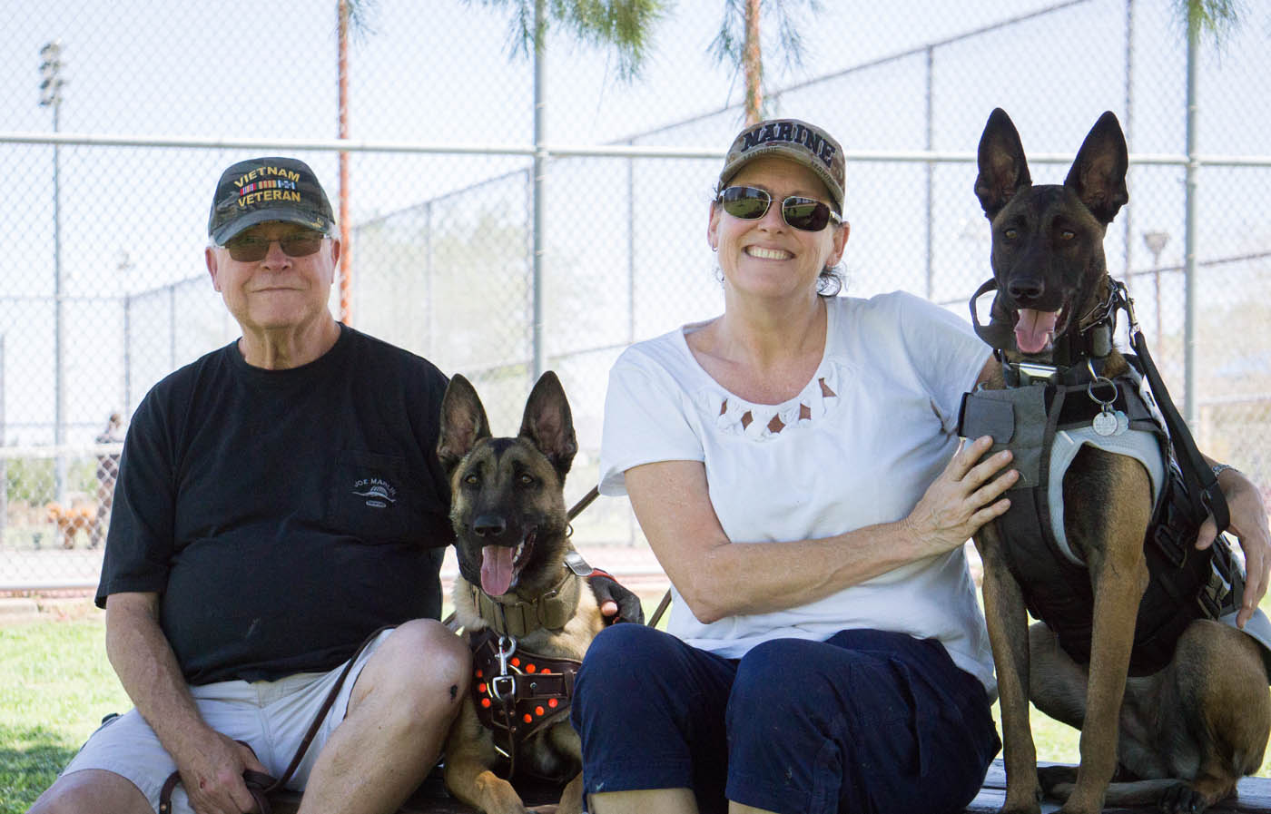 Two loving dobermans with their owners - if you are in need of doberman pinscher training in Myrtle Beach, SC contact Dog Training Elite today!.