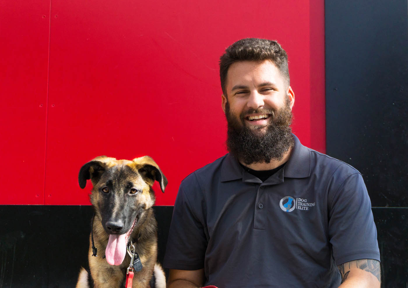 A Dog Training Elite in Cincinnati owner smiling with his dog in Cincinnati, OH.