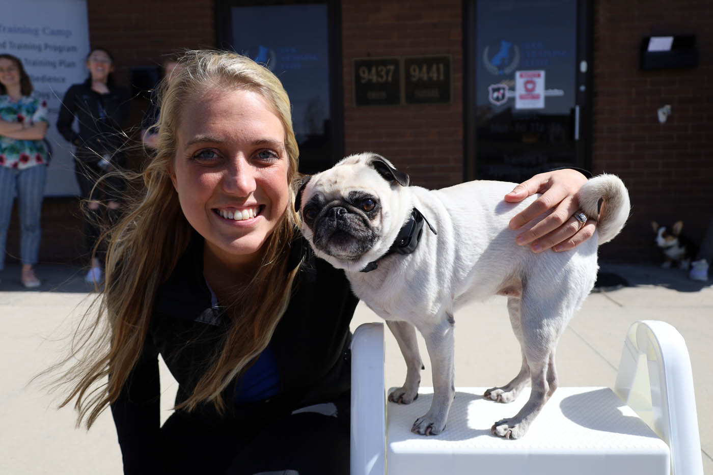 A dog owner with her pug who has received e-collar dog training in Colorado Springs, CO from Dog Training Elite.