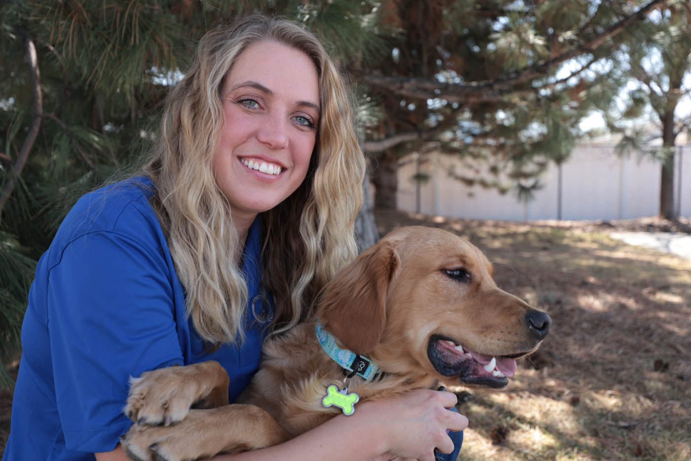 A therapy dog handler with their dog trained by Dog Training Elite in Cincinnati.